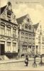 Undated postcard featuring a soldier in front of
"Yperen Gildenhuizen op de Veemarkt"(Yperen Guild Houses on the Veemarkt)in Belgium.